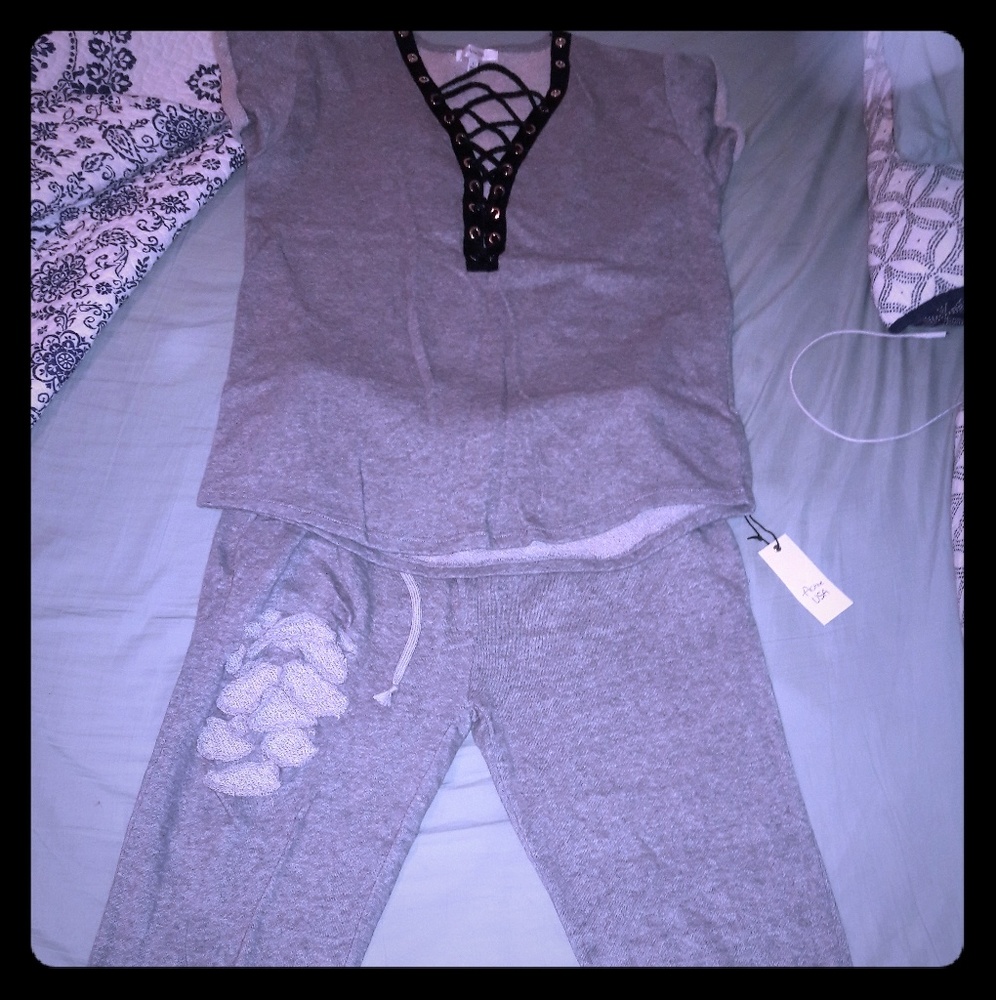 Stylish lace up sweat suit ,never worn.